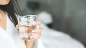 woman holding a glass of water